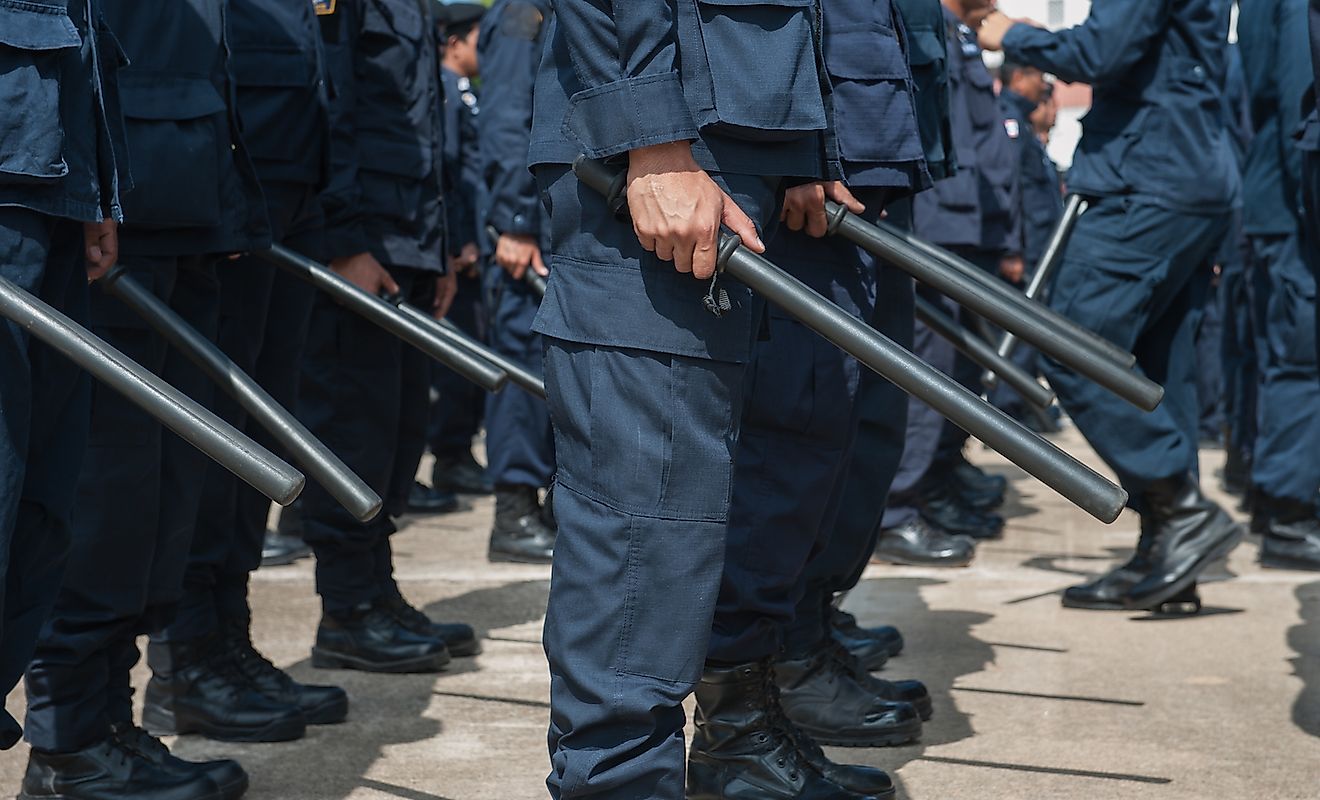 Police with batons and not guns. Image credit: Somsak Suwanput/Shutterstock.com