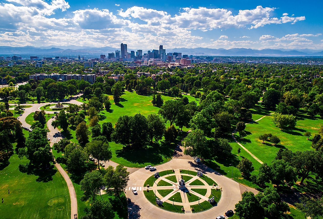 Aerial drone view high above Denver, Colorado with the downtown skyline and Rocky Mountains. Image credit Roschetzky Photography. 
