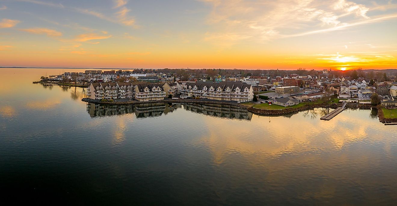 Aerial sunset panorama of Havre de Grace, Maryland, with vibrant orange sky and clouds reflecting on the Susquehanna River and the Chesapeake Bay.