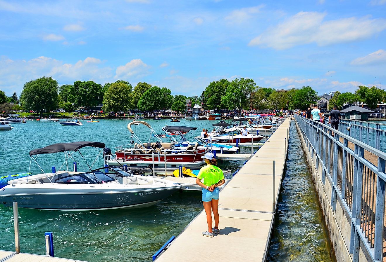 Pier and luxury boats docked in the Skaneateles Lake, New York. Image credit PQK via Shutterstock