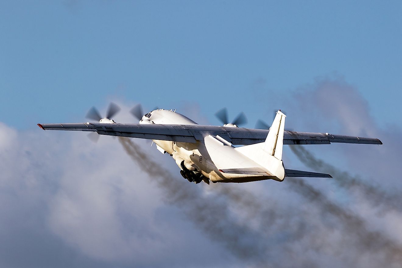 Old cargo airplane taking off with turboprop engine smoke emission. Image credit: VanderWolf Images/Shutterstock.com