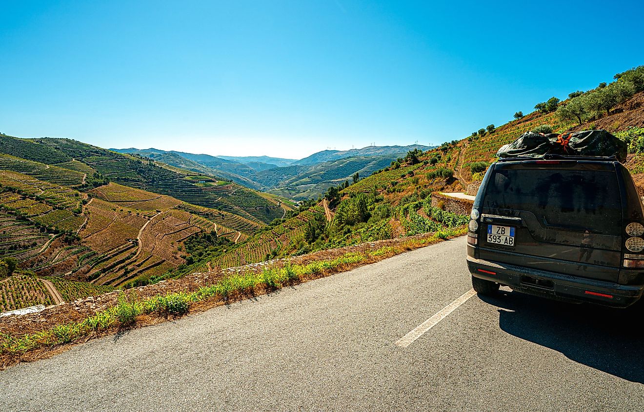 Lifestyle photo of  Land Rover driving along scenic coastline. Image credit FranciscoMarques via Shutterstock