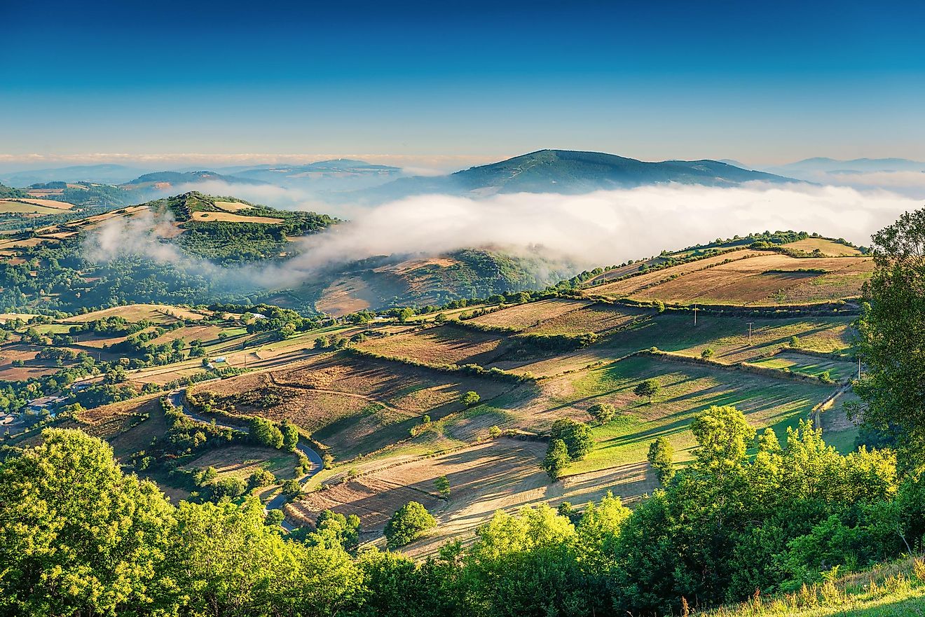 The rolling green landscape of Galicia with its characteristic low-lying clouds.