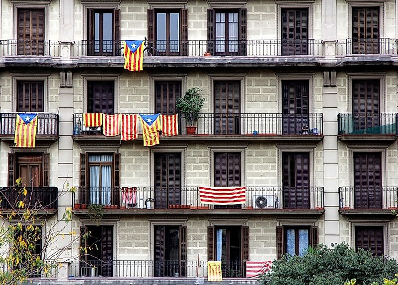 Catalan flags are flown outside houses in Barcelona by Catalonian Spaniards who desire a separate, autonomous Catalon state.