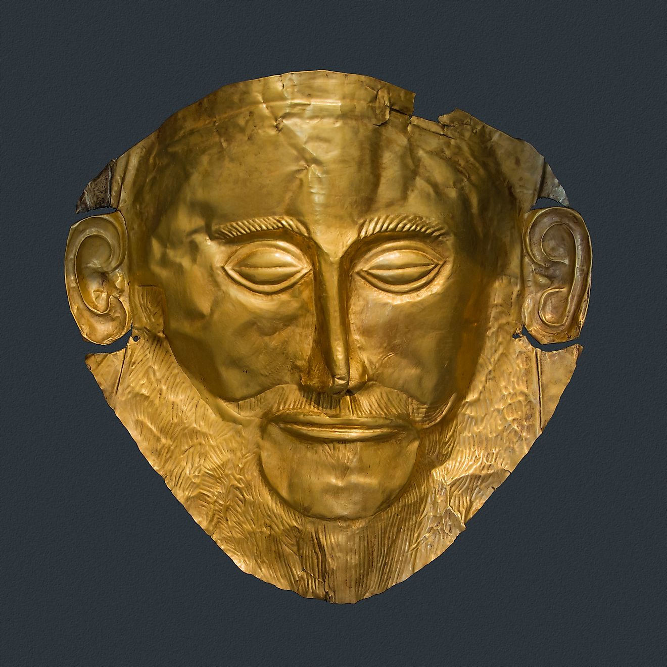 The Mask of Agamemnon, made at Mycenae around the 16th century BCE (National Archaeological Museum of Athens, CC0, via Wikimedia Commons)