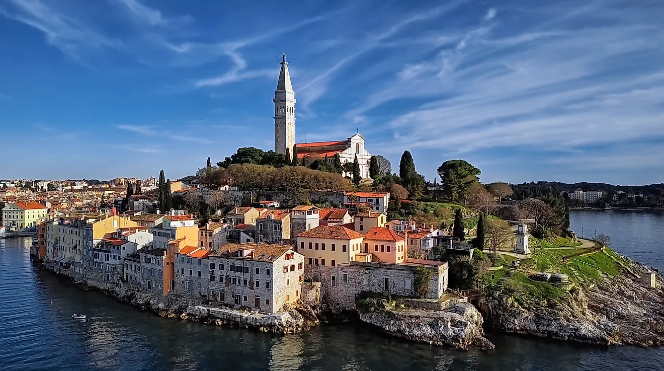 Scenic view of Rovinj old town with colorful houses and Church of St. Euphemia overlooking Adriatic Sea in Croatia.