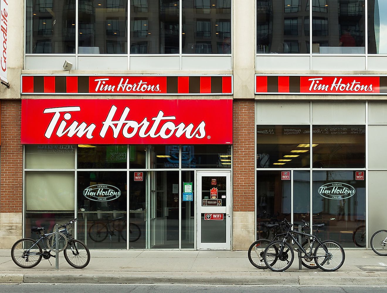 The outside of a Tim Hortons Coffee Shop in Canada. Image credit: Mikecphoto/Shutterstock.com