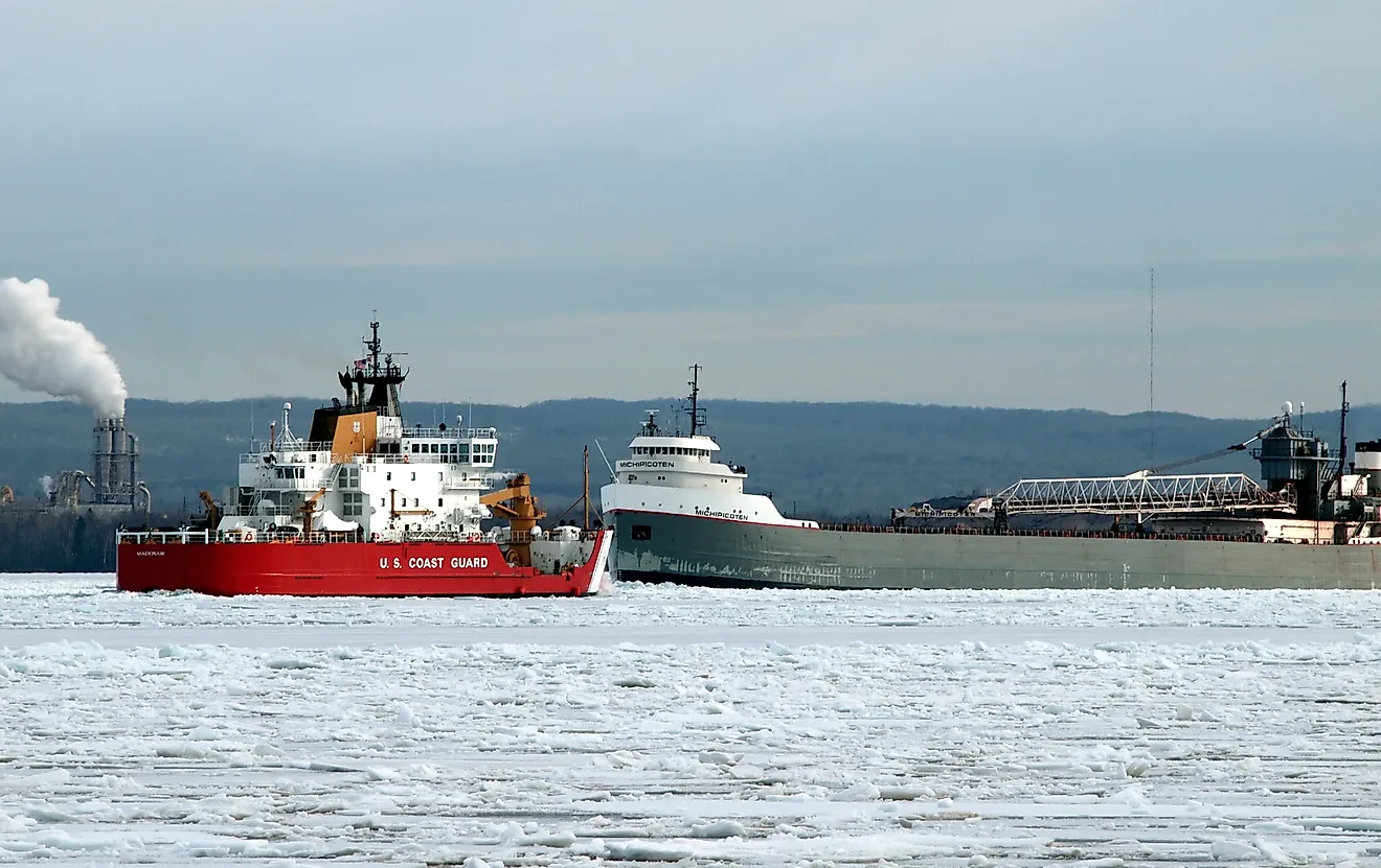 US Coast Guard ship and a grey cargo freighter near the Soo Locks. Editorial credit: T-I / Shutterstock.com