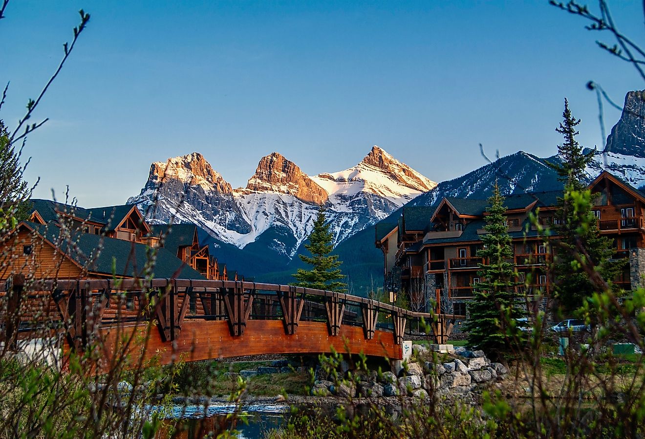 Town of Canmore in Alberta, Canada with mountain view and bridge.