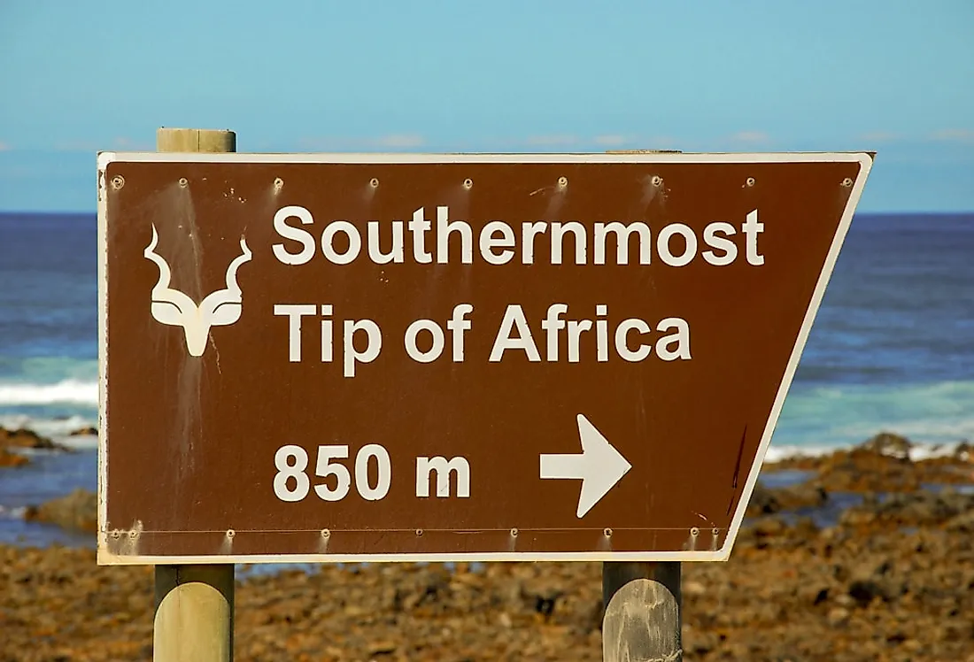 A sign directing visitors towards Cape Agulhas, the southernmost point in Africa. 