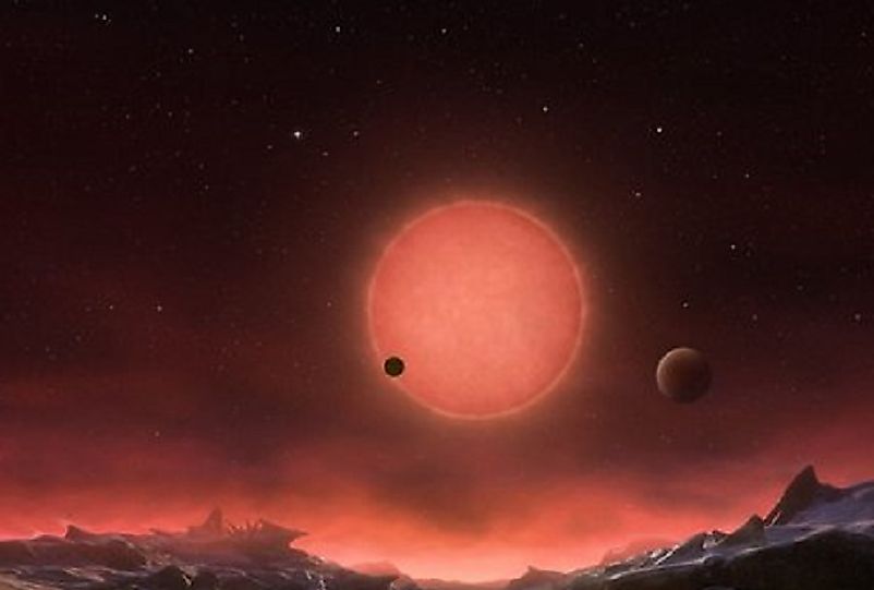 A NASA artist's conception of a possible view of the TRAPPIST I red dwarf star and two of its orbiting planets as seen from a third one.