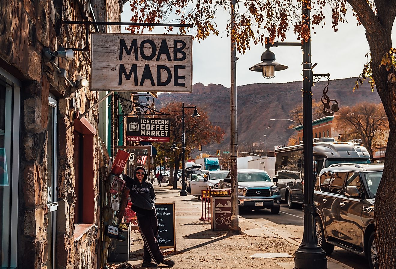A man poses for a photo in downtown Moab, Utah. Image credit Ilhamchewadventures via Shutterstock