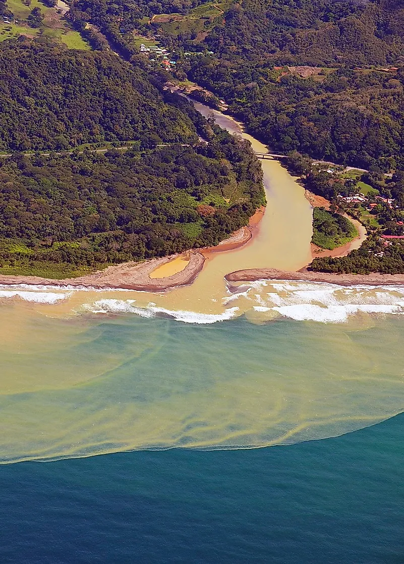 A Costa Rican river discharging massive amounts of its silt-laden waters (caused by erosion) into the ocean.