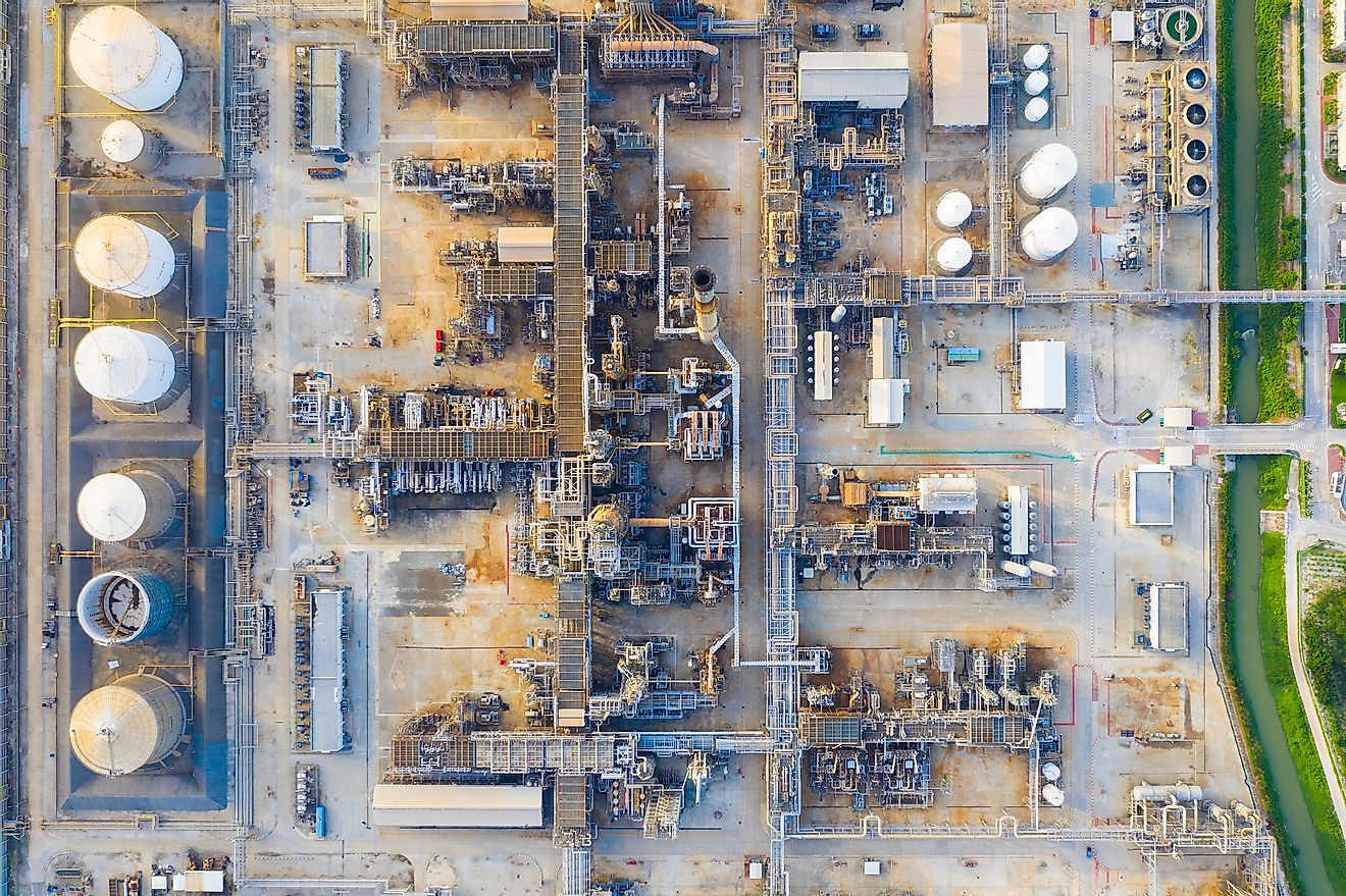 Top view of oil refinery plant chemical factory and power plant with many storage tanks and pipelines in industrial estate. Image credit: structuresxx/Shutterstock.com
