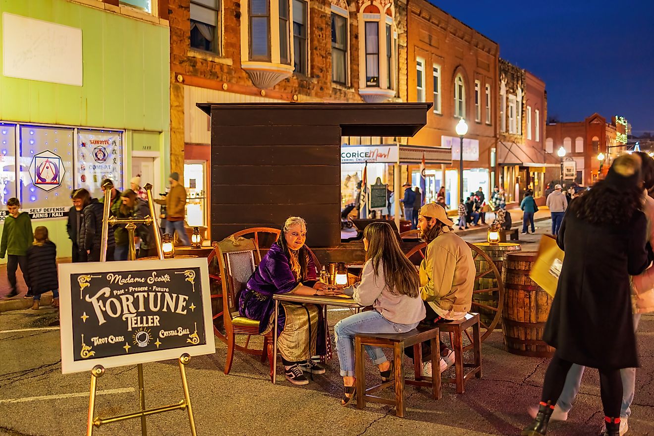 A fortune teller seated in a Victorian-style setting during the famous Guthrie Victorian Walk in Oklahoma.