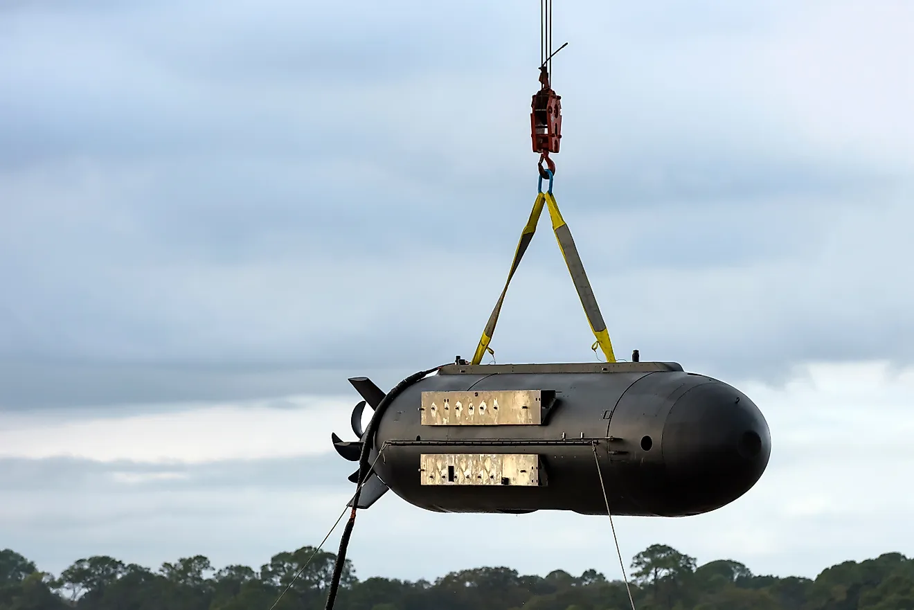 Black unmanned submarine being hoisted from the gulf of mexico