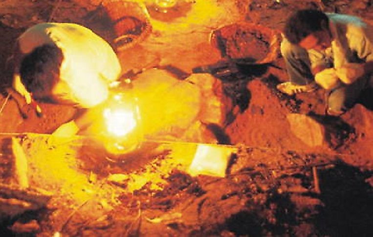 Archaeologists work into the night at a dig site in the Lenggong Valley.