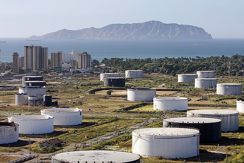 Petroleum refineries and oil holding tanks dominate the landscape outside the Venezuelan port city of La Cruz.