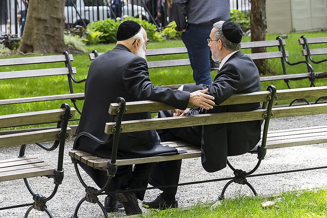 Men wearing kippah on a bench in New York City. The Jewish diaspora can be found over the world, with large populations in North American cities such as New York.  Editorial credit: alredosaz / Shutterstock.com.