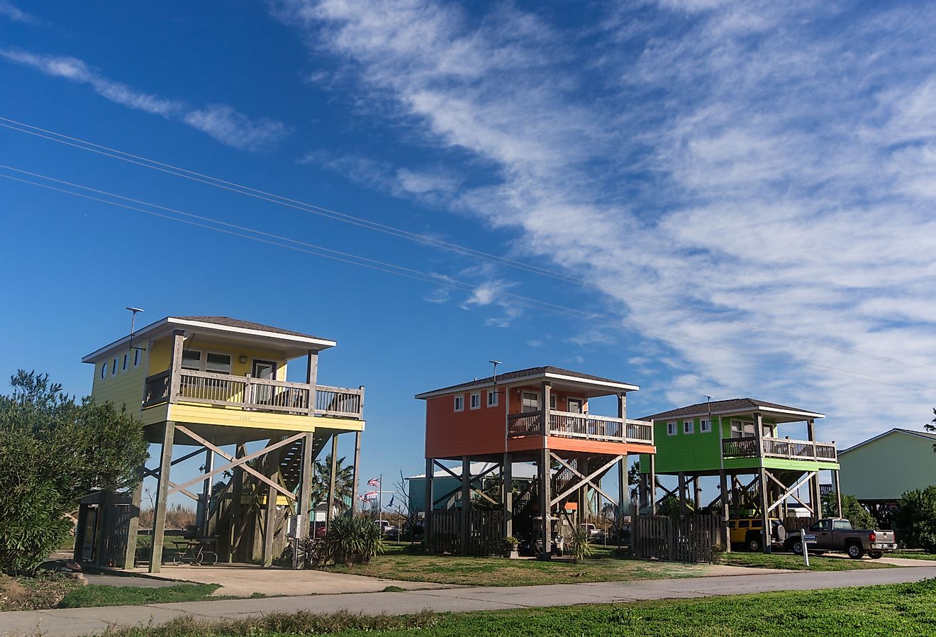 Row of colorful houses built on high stilts on the coast of Louisiana, Holly Beach. Image credit Heidi Besen via Shutterstock