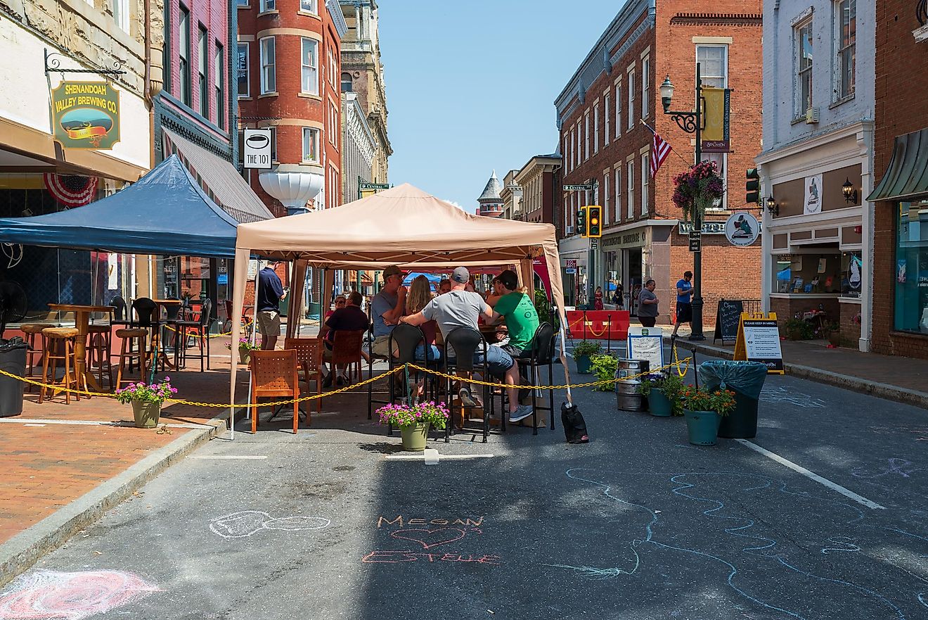 Restaurant patrons dine under the shade of tents on a summer day in Staunton, Virginia