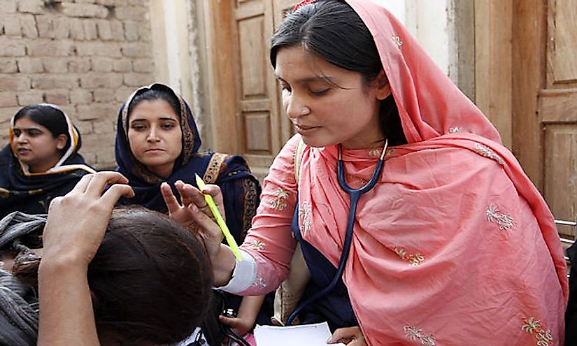 A female doctor with the International Medical Corps examining patients in Pakistan