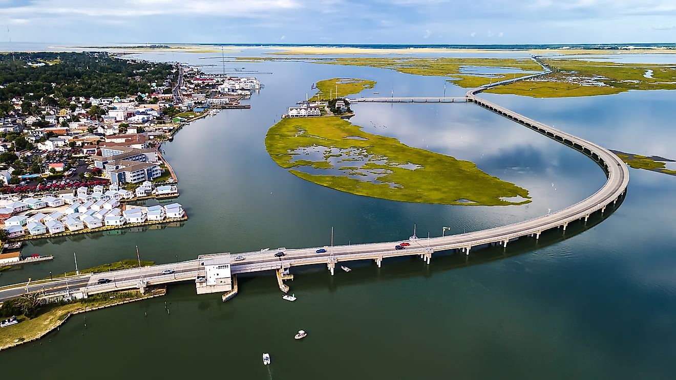 Drone view of Chincoteague bridge across the Chincoteague Bay in Virginia, showcasing views of the waterfront.
