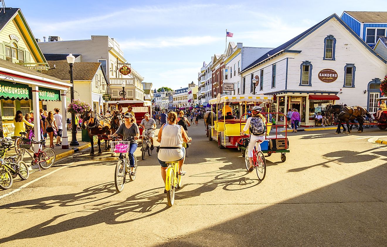 Vacationers explore Market Street on Mackinac Island, Michigan, known for its shops and restaurants. Editorial credit: Alexey Stiop / Shutterstock.com