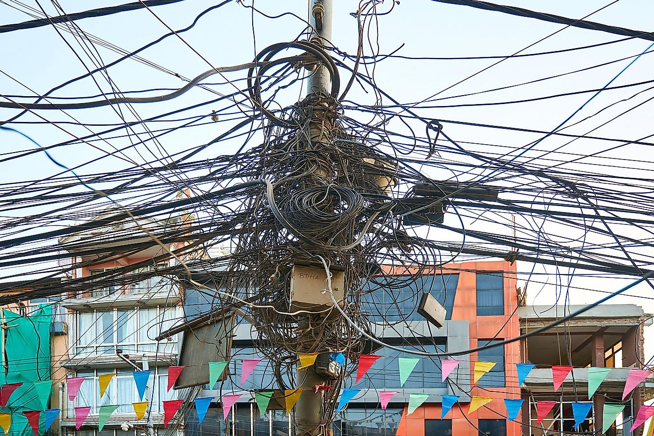 The chaos of cables and wires connections on the pole in Kathmandu, Nepal creating visual pollution. Image credit: Vladimir Zhoga/Shutterstock.com