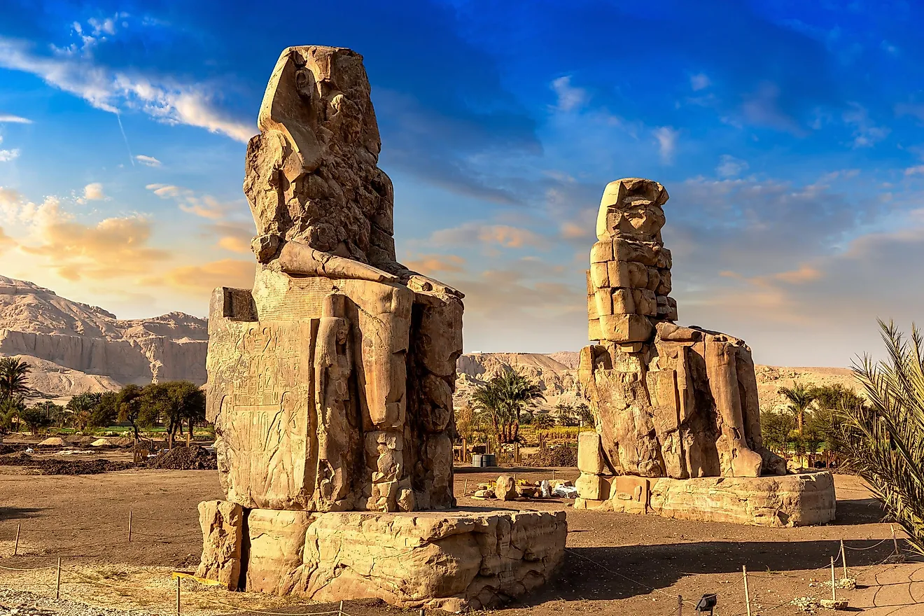Colossi of Memnon in Luxor, Valley of Kings, Egypt. These two massive stone statues are of the Ancient Egyptian Pharaoh, Amenhotep III.