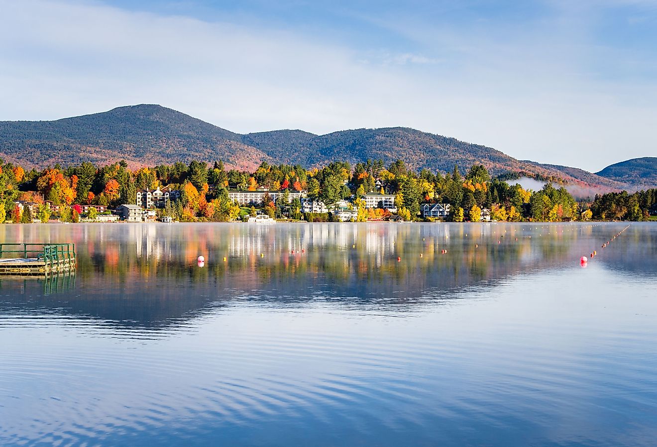 View of mountainous Lake Placid with town on the shore in autumn. 
