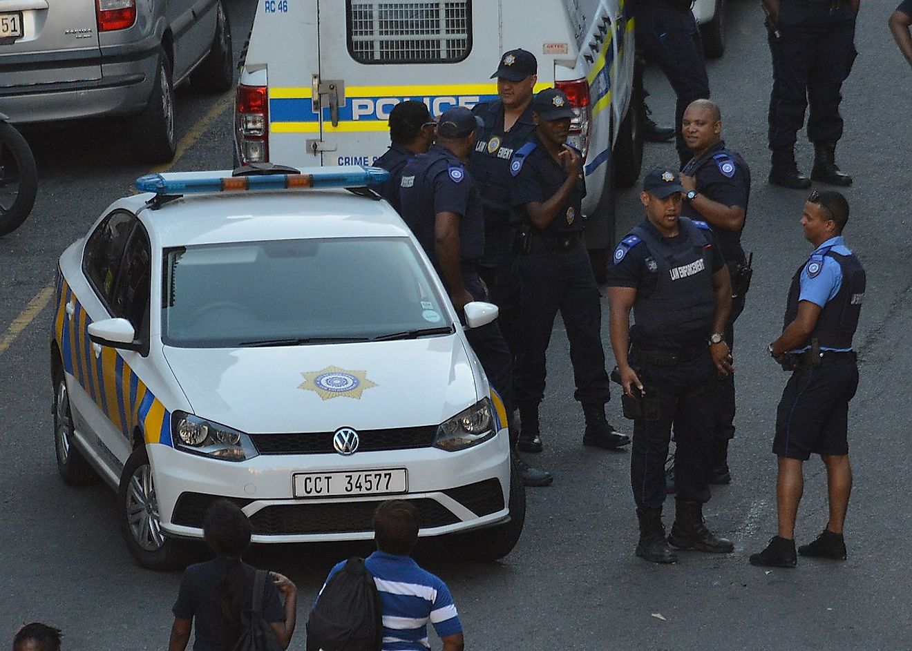 A group of Cape Town Metropolitan Police officers in various uniforms with a Metro Police vehicle. Image credit: Discott/Wikimedia.org