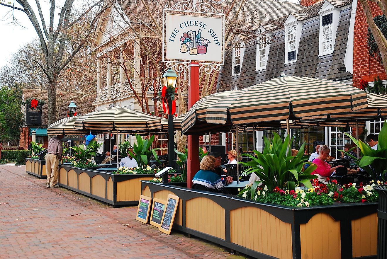 Folks enjoy an alfresco meal in Merchants Square, a retail and dining area near Colonial Williamsburg, Virginia, via James Kirkikis / Shutterstock.com