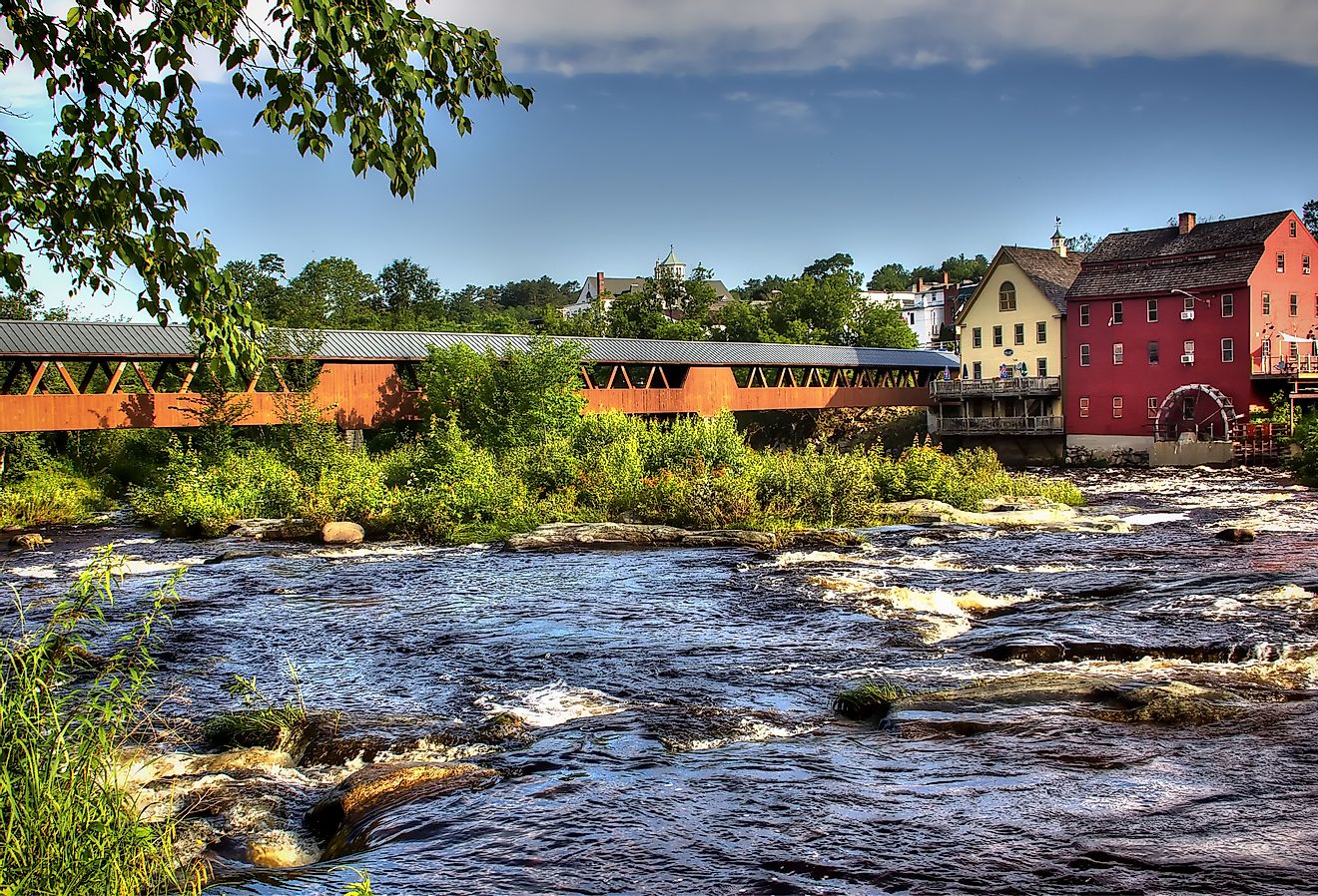 The River Walk Covered Bridge with the Grist mill on the Ammonoosuc River in Littleton, New Hampshire.