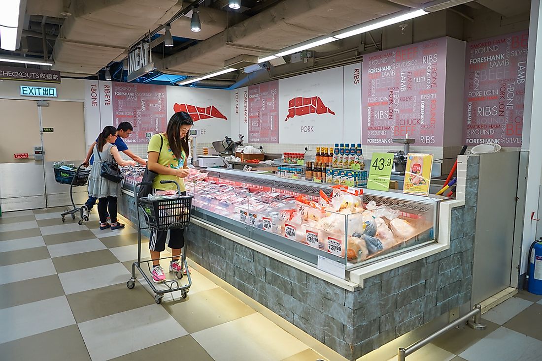 Women shop at a meat market in Hong Kong. Editorial credit: Sorbis / Shutterstock.com.