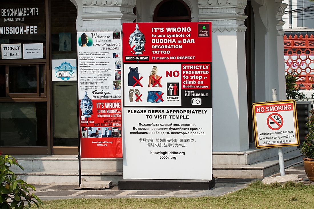 A photo of a poster in Thailand warning tourists to interact with Thai culture appropriately. Editorial credit: Sombat Muycheen / Shutterstock.com.