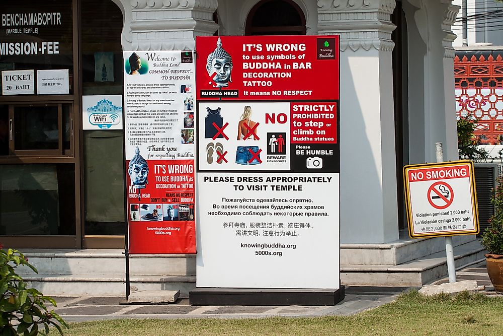 A photo of a poster in Thailand warning tourists to interact with Thai culture appropriately. Editorial credit: Sombat Muycheen / Shutterstock.com.