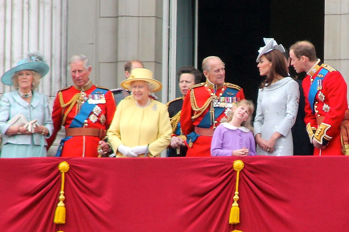 The British Royal Family with Queen Elizabeth II in the yellow dress.
