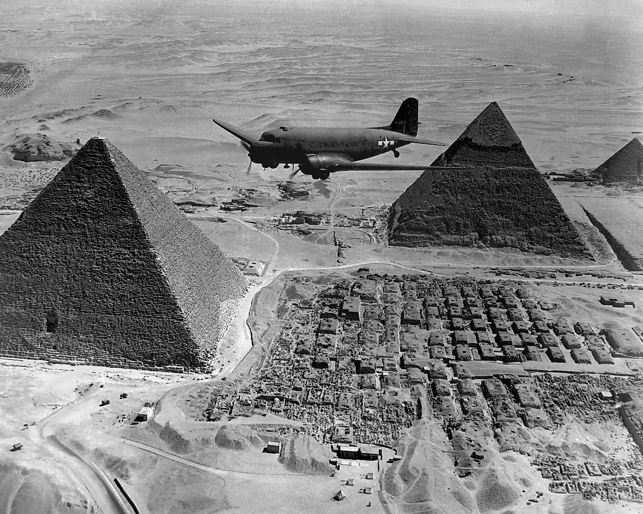 American Air Transport Command plane flies over the pyramids of Egypt. 