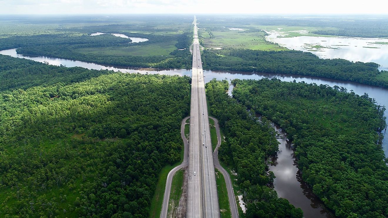 Busy highway surrounded by trees and the gorgeous, curving Sabine River. 