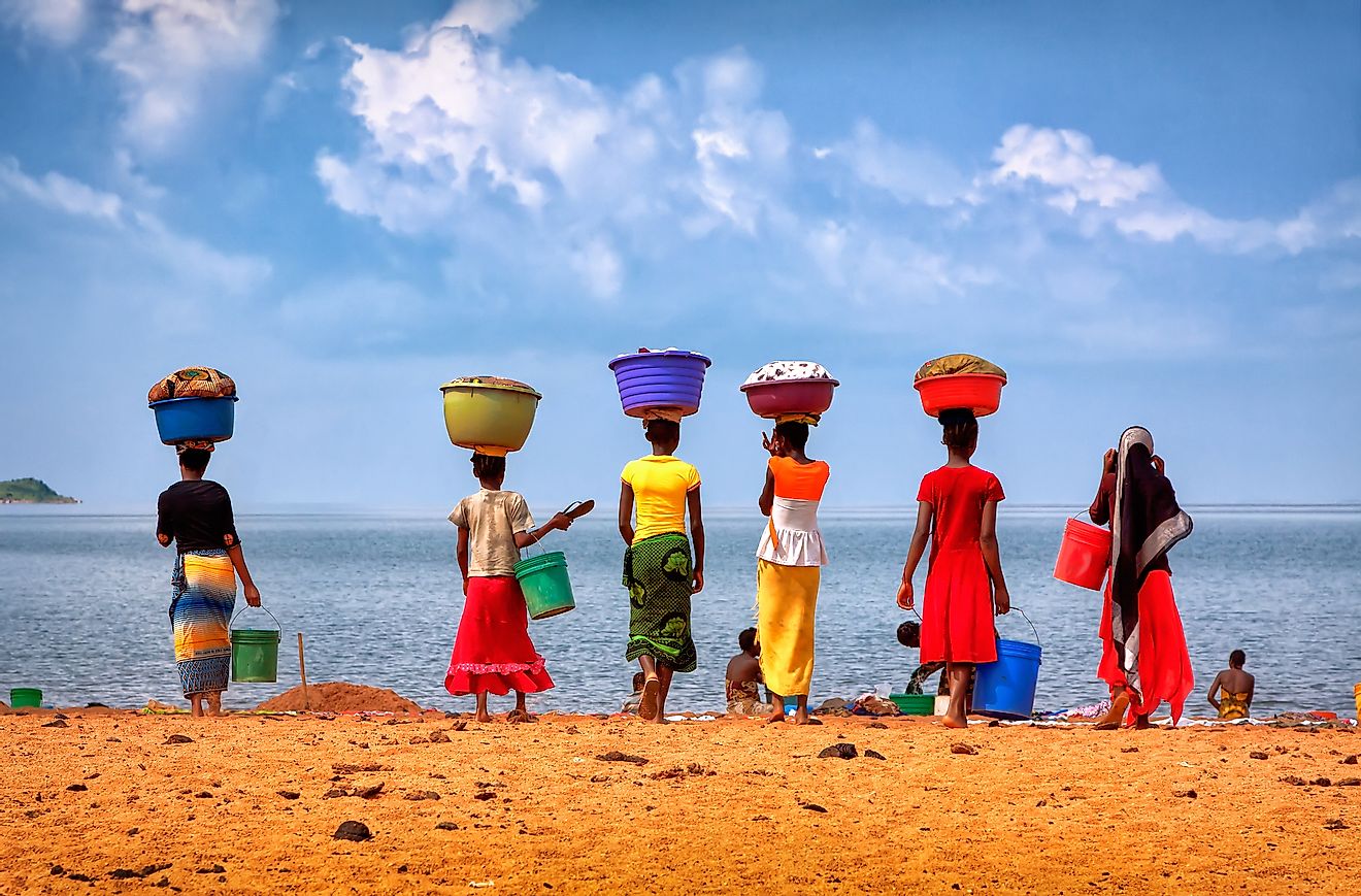 Women with their laundry at Lake Tanganyika, TanzaniaEditorial credit: Yury Birukov / Shutterstock.com