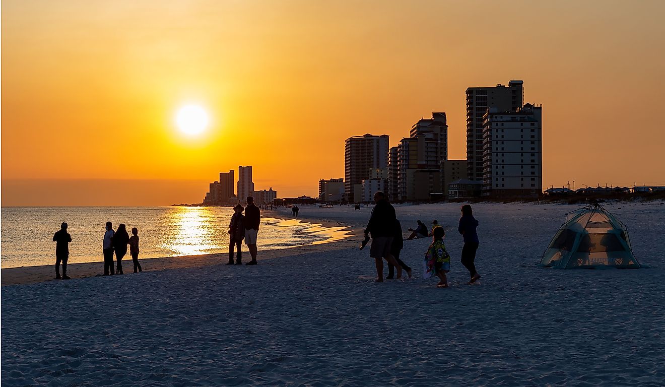 People gathering on the beach to watch the sun set. Gulf Shores is an increasingly popular tourist location. Editorial credit: James.Pintar / Shutterstock.com
