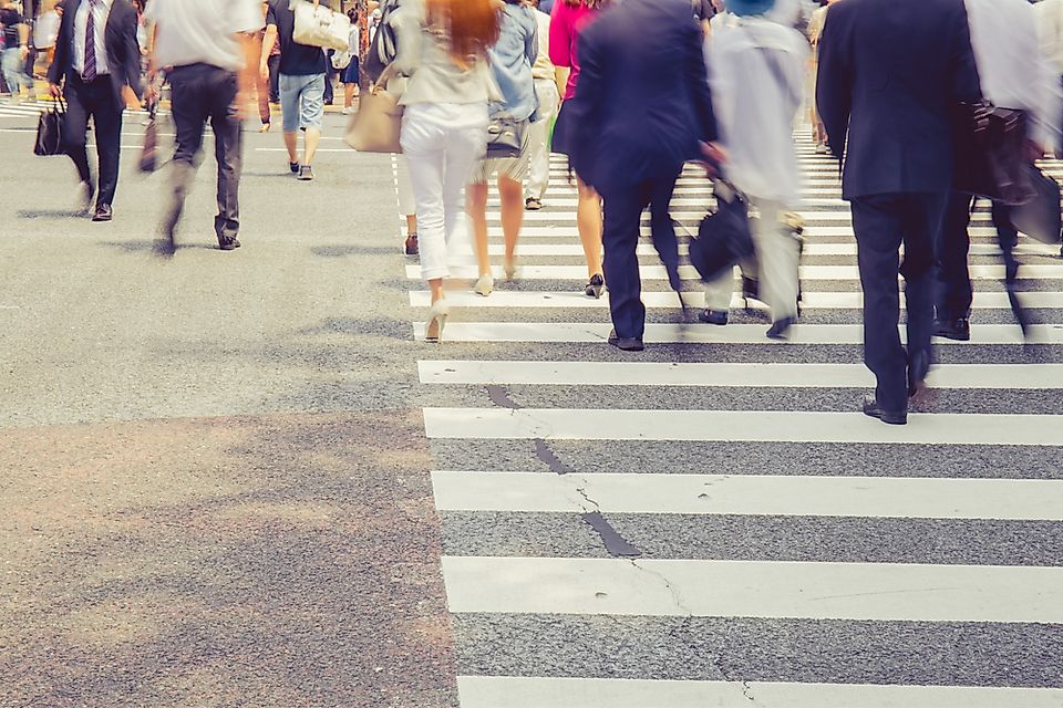 Pedestrians crossing a busy intersection.