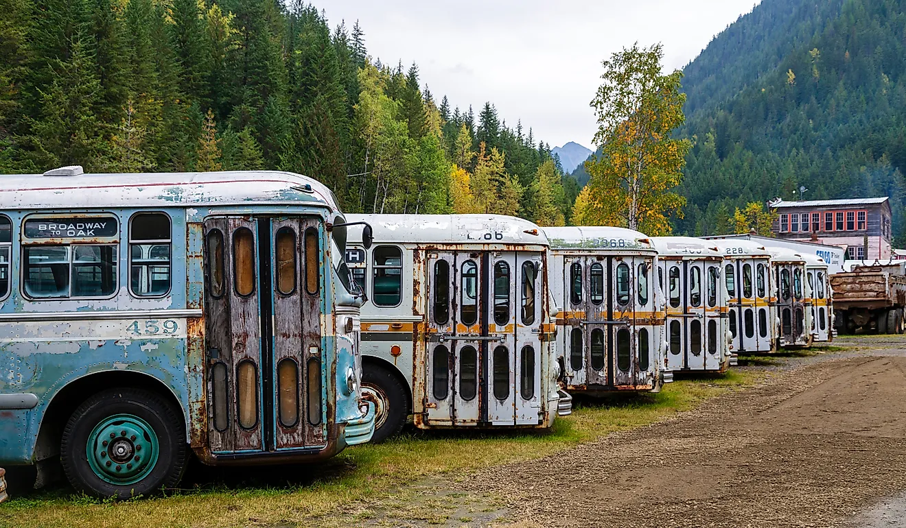 A collection of old trolley city buses in the ghost town of Sandon, British Columbia, Canada. Editorial credit: Nalidsa / Shutterstock.com