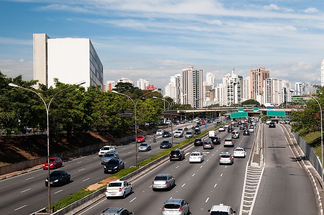 Traffic in Sao Paulo moving steadily, although the high volume of cars could quickly cause congestion. 