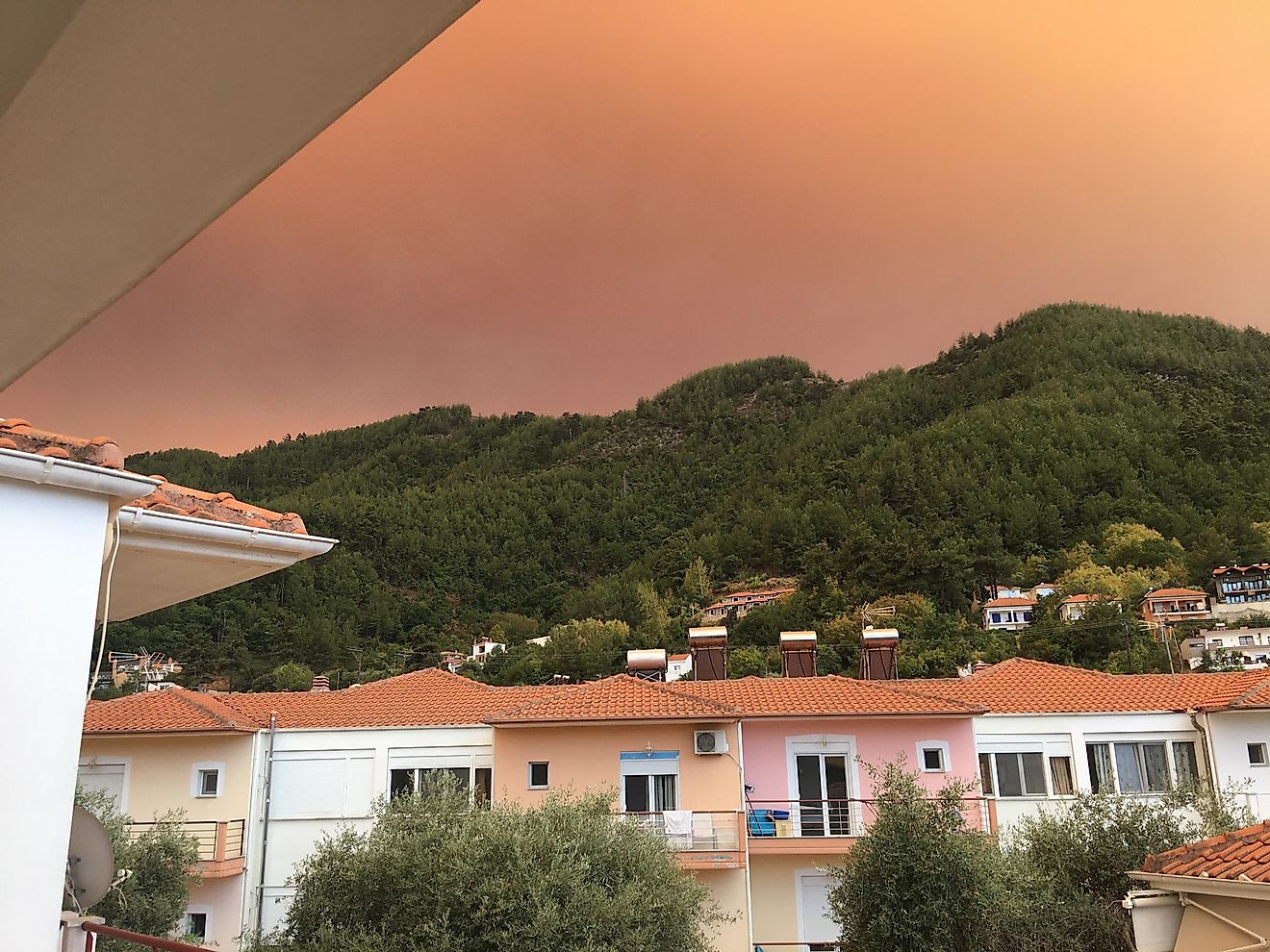 Smoke from the wildfires in Greece rolls over the hills of Skala Potamias, on the island of Thassos. Photo: Andrew Douglas