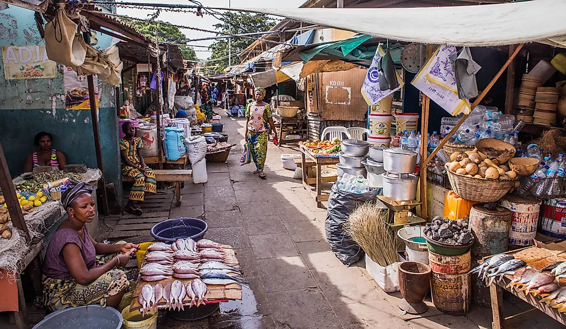 People at a street market in the Gambia. Editorial credit: Damian Pankowiec / Shutterstock.com.