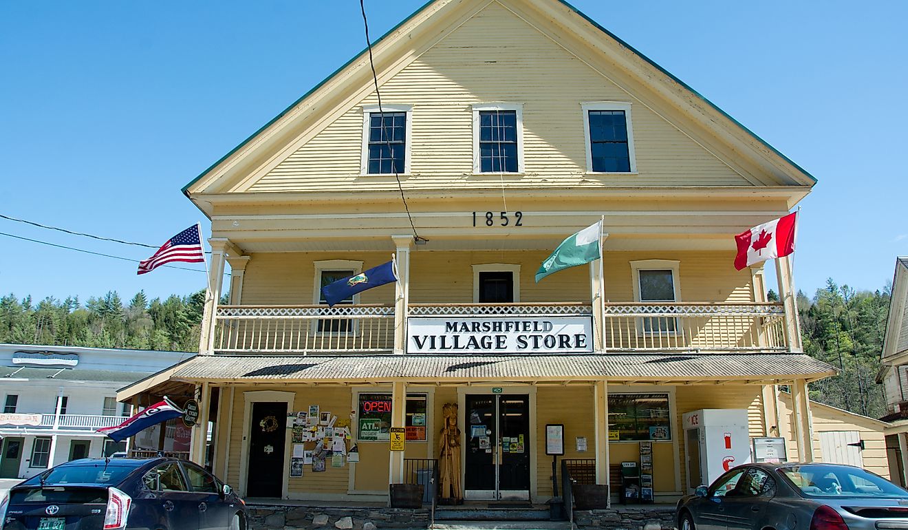 Flags flap in the breeze over the parking lot of the Marshfield Village Store. Editorial credit: Erika J Mitchell / Shutterstock.com