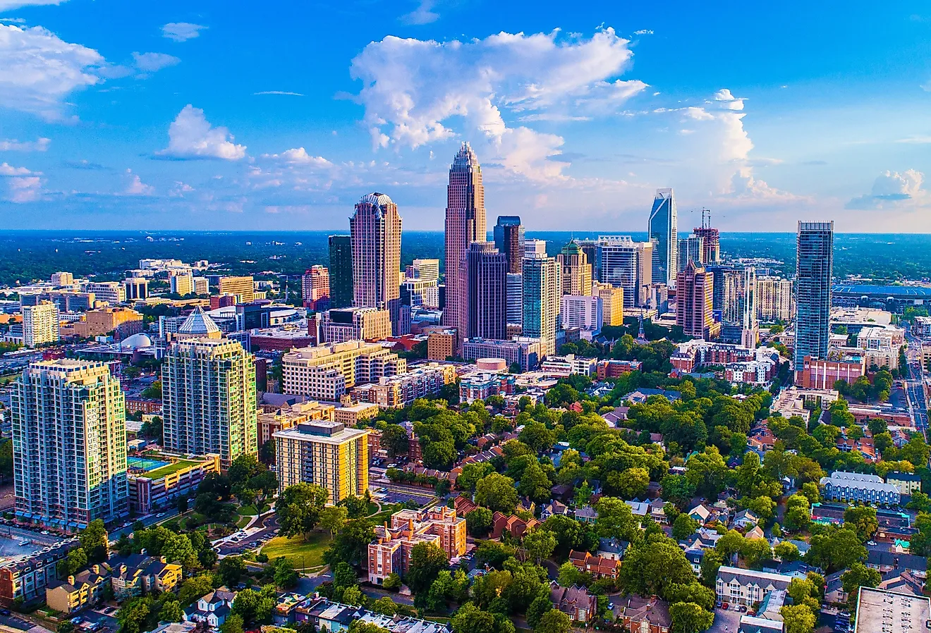 Charlotte North Carolina skyline on a bright sunny day with a few clouds in the sky.
