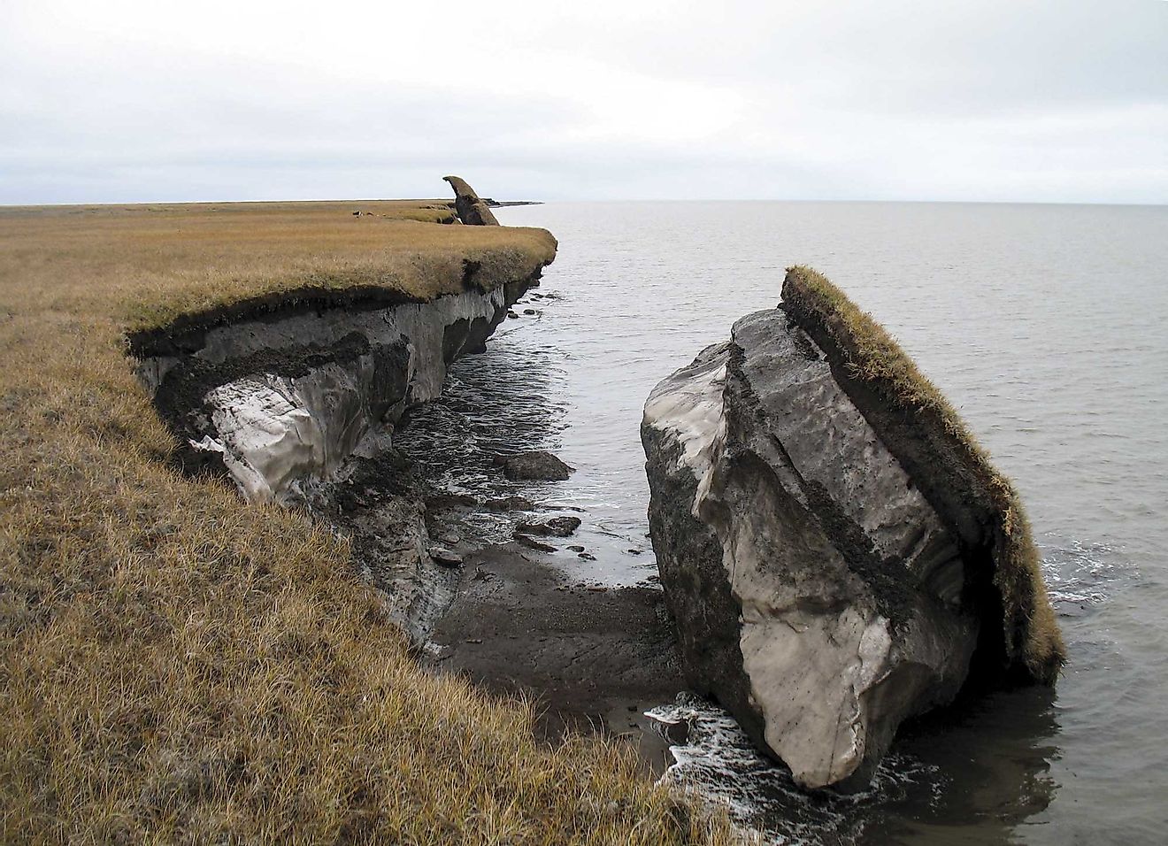 In this photo you can see a collapsed block of ice-rich permafrost along Drew Point, Alaska. Image credit: Benjamin Jones, USGS